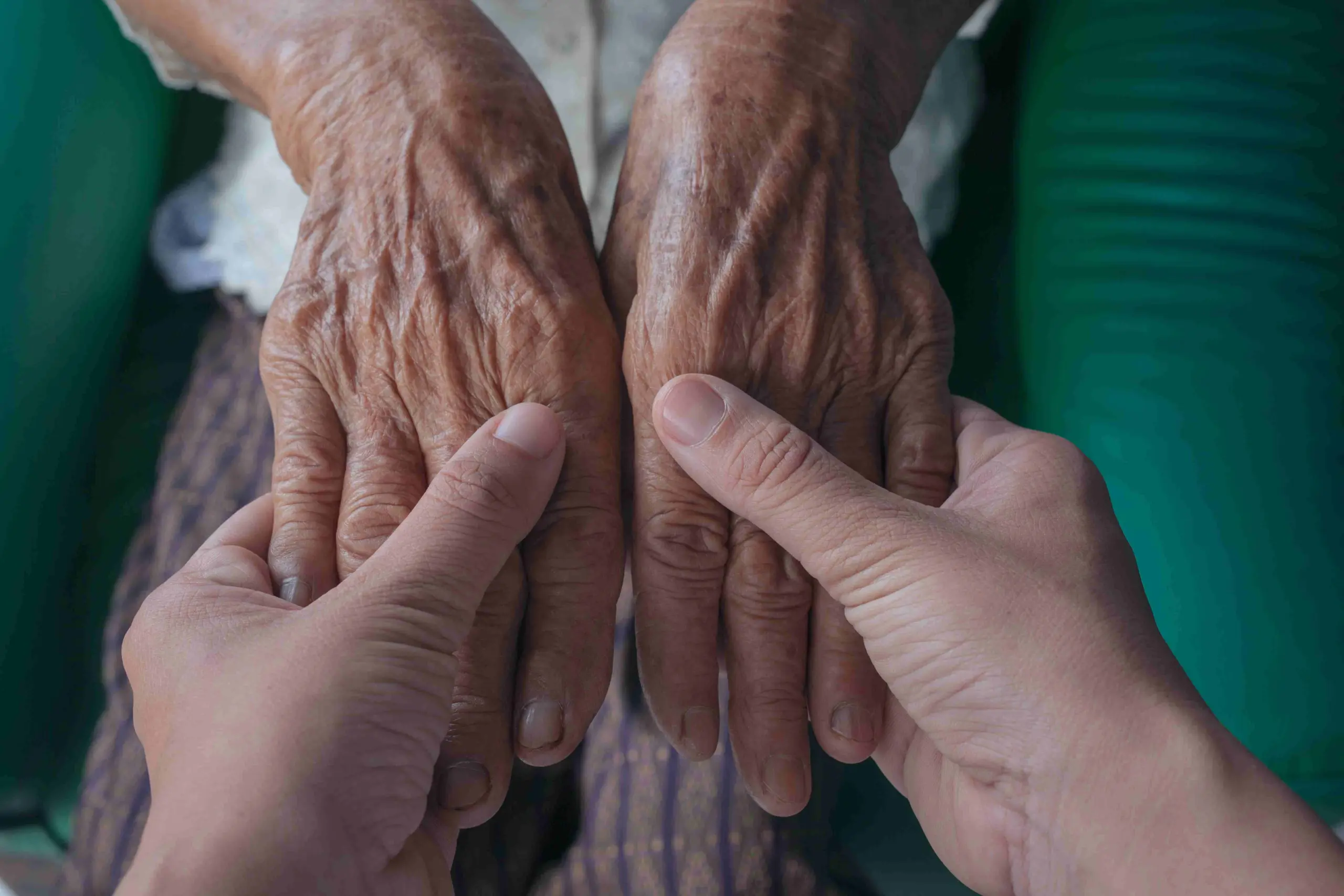 young-woman-holding-elderly-woman-s-hand_11zon